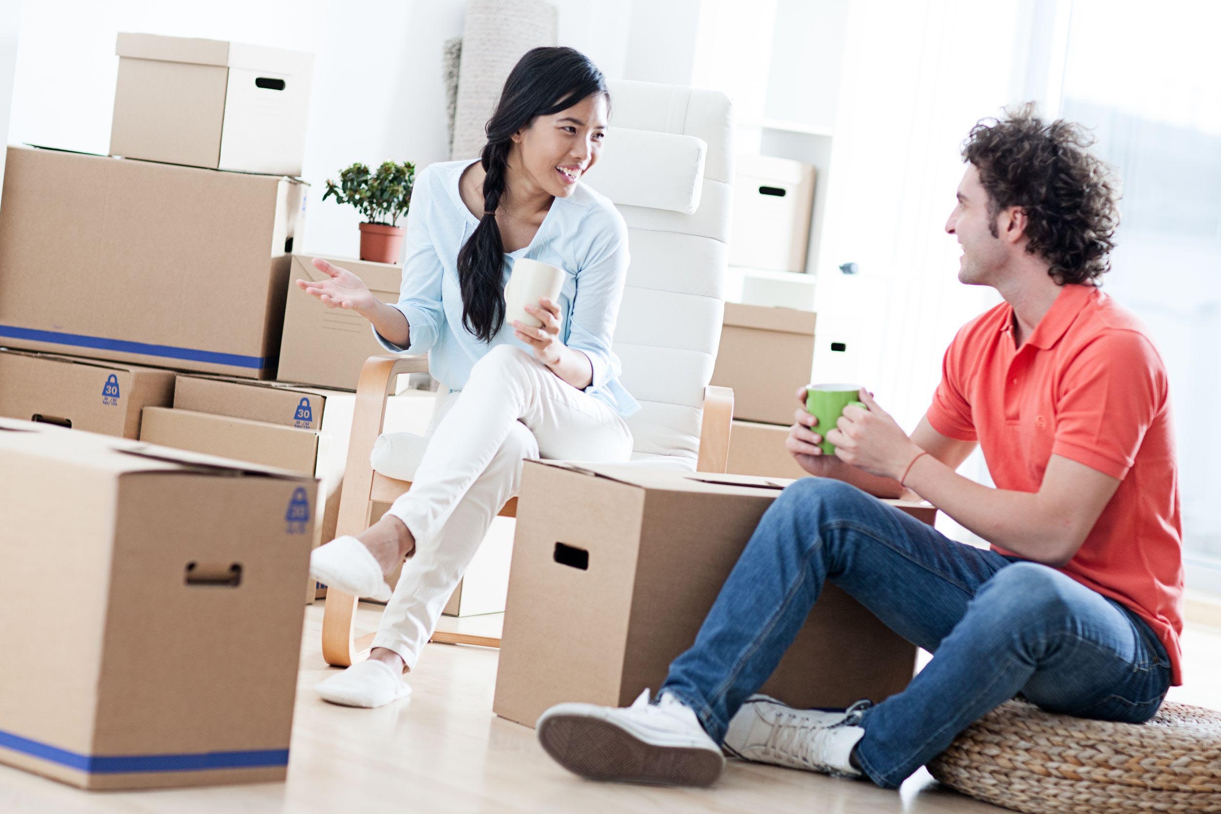 couple sitting on moving boxes